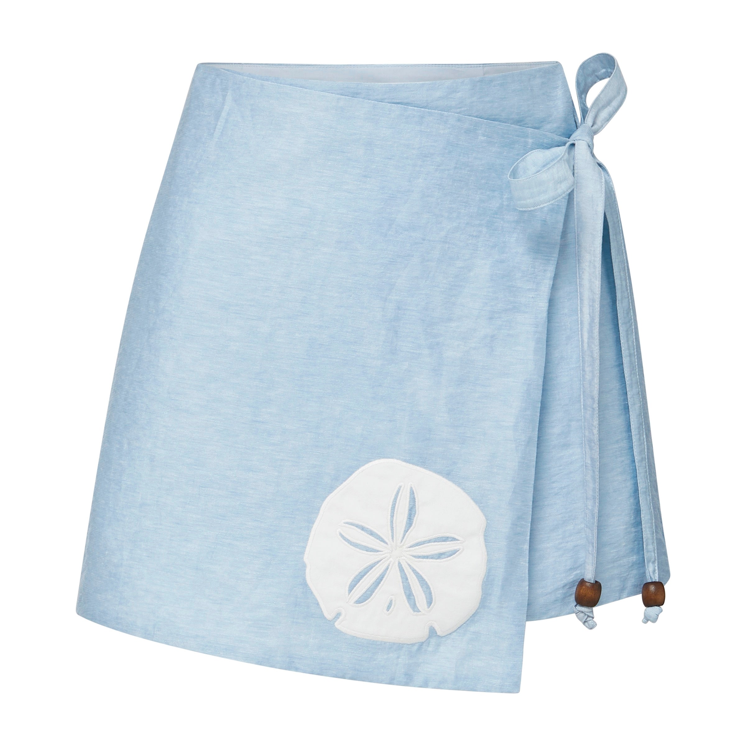 Light blue wrap skirt with a white appliquéd sand dollar design and wooden beads at the end of the ties on a white background.