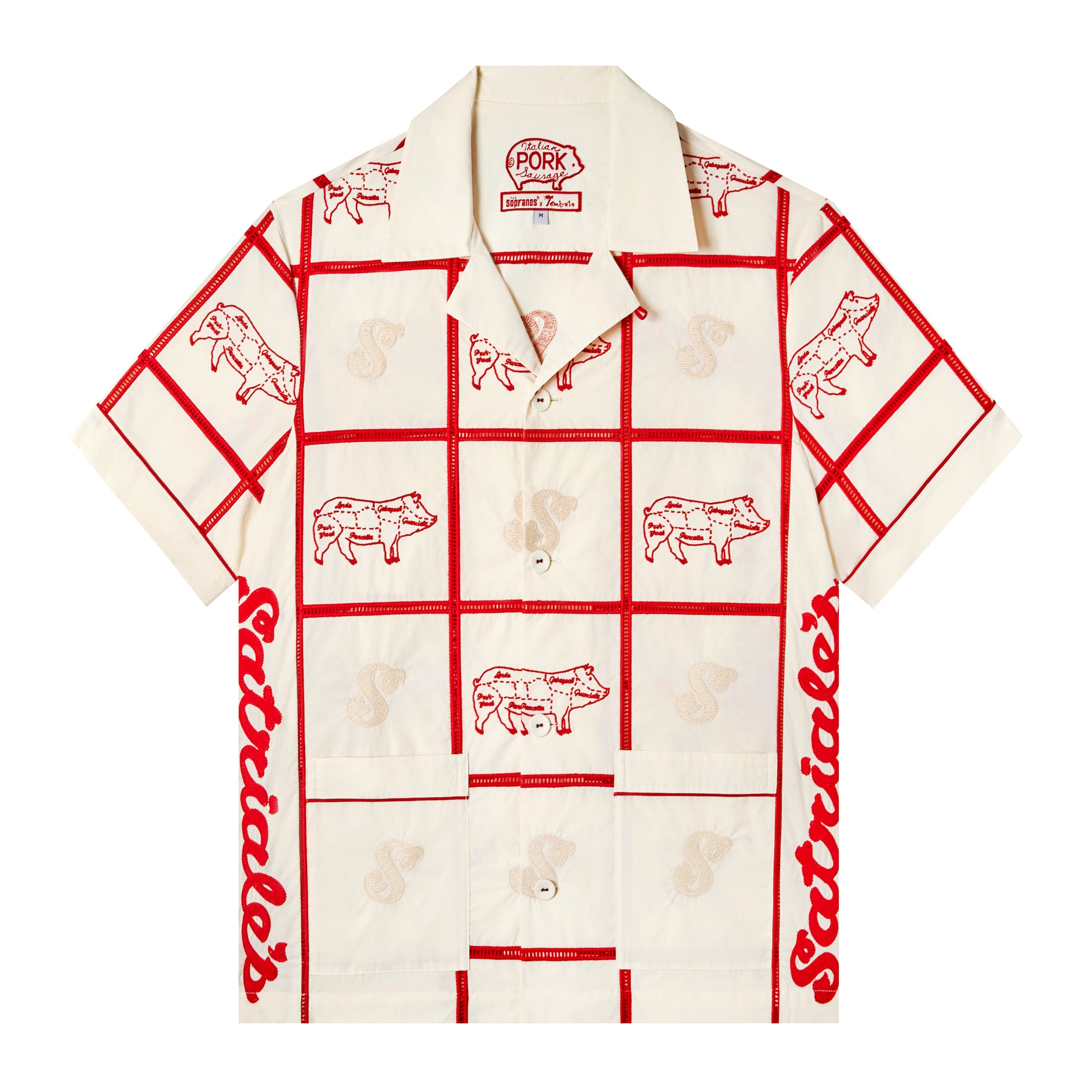 Front-facing product image of 'The Sopranos' Satriale's (Gabagool) in cream coloring that features red square panels joined by ‘ladder’ lace embroidery, red piping on cuffs and pocket strips, pig embroidery on alternating panels, labeled with various cuts in Sopranos parlance: "gabagool", "pruh-zhoot", etc, and a custom woven 'The Sopranos' x Tombolo interior label that includes a special pig logo from Satriale's storefront.