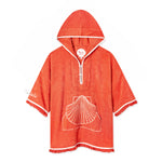 Orange terrycloth poncho with white trim, featuring a large embroidered seashell design on the front pocket and the word 'Tombolo' stitched in white. 