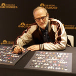 Tom Broecker signing SNL posters while wearing the SNL Souvenir Jacket. 