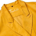 Close-up product image of the yellow corduroy collar, and the interior stitching reading 'Tombolo'. 