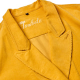 Close-up product image of the yellow corduroy collar, and the interior stitching reading 'Tombolo'. 