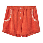 Front view of orange terry cloth shorts with white button fly and coiled white embroidery along the pocket openings.