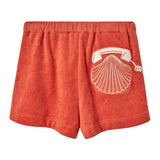 Back view of orange terry cloth shorts featuring a white embroidered rotary phone with a seashell design on the right side.