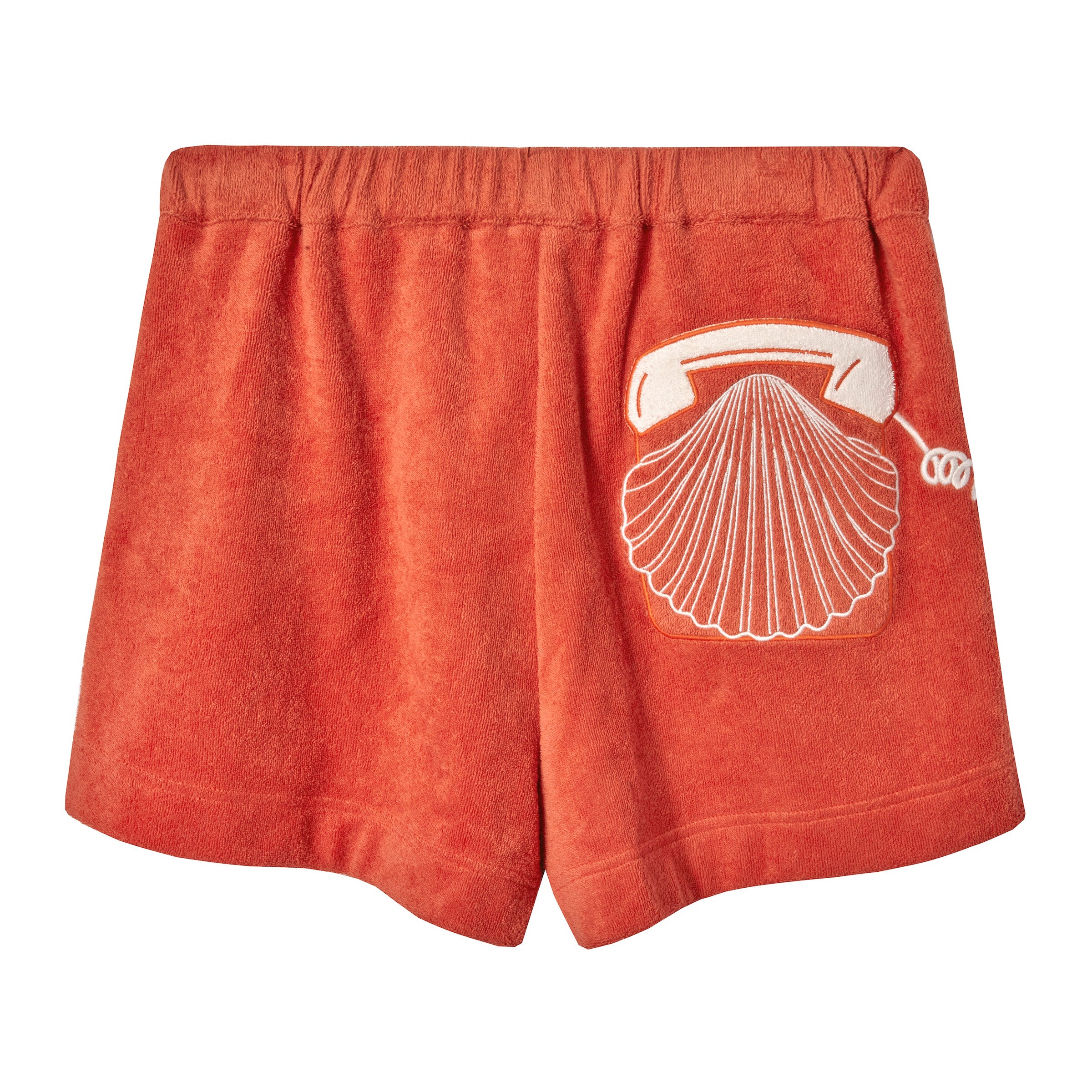 Back view of orange terry cloth shorts featuring a white embroidered rotary phone with a seashell design on the right side.
