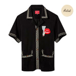 Black short-sleeve terry cloth shirt with cream embroidered trim and an embroidered graphic of red lips holding a lit cigarette on the left chest.