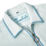 Close-up image of the 'Standard Issue' Cabana's (Sky Blue) interior chain-stitched label that says 'Tombolo,' and the antique brass two-way ring pull zipper. 