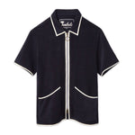 Front-facing product image of the 'Standard Issue' Cabana (Midnight Blue) made of 100% Organic Terry Cloth with a two-way, antique-brass ring pull zipper, twin curved patch pockets, chain-stitched Tombolo interior label, and 1/8" edge binding along collar, zipper, and pockets, all shot on a white background.