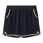 Front-facing product image of the 'Standard Issue' Cabana Shorts (Midnight Blue) made of 100% Organic Terry Cloth with an elastic waistband, pull-on style with relaxed fit throughout, 1/4" edge-binding on pocket and leg openings (including v-slit on side seam), signature Tombolo v-slit back pocket, sewn pleats, and an internal drawstring.