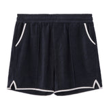 Front-facing product image of the 'Standard Issue' Cabana Shorts (Midnight Blue) made of 100% Organic Terry Cloth with an elastic waistband, pull-on style with relaxed fit throughout, 1/4" edge-binding on pocket and leg openings (including v-slit on side seam), signature Tombolo v-slit back pocket, sewn pleats, and an internal drawstring.