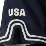 Navy blue shirt with white embroidery and white 'USA' logo patch.