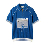 Blue terry cloth short sleeve cabana shirt with white striped trim, half zip collar, and white mesh chest pocket with Statue of Liberty soccer patch.