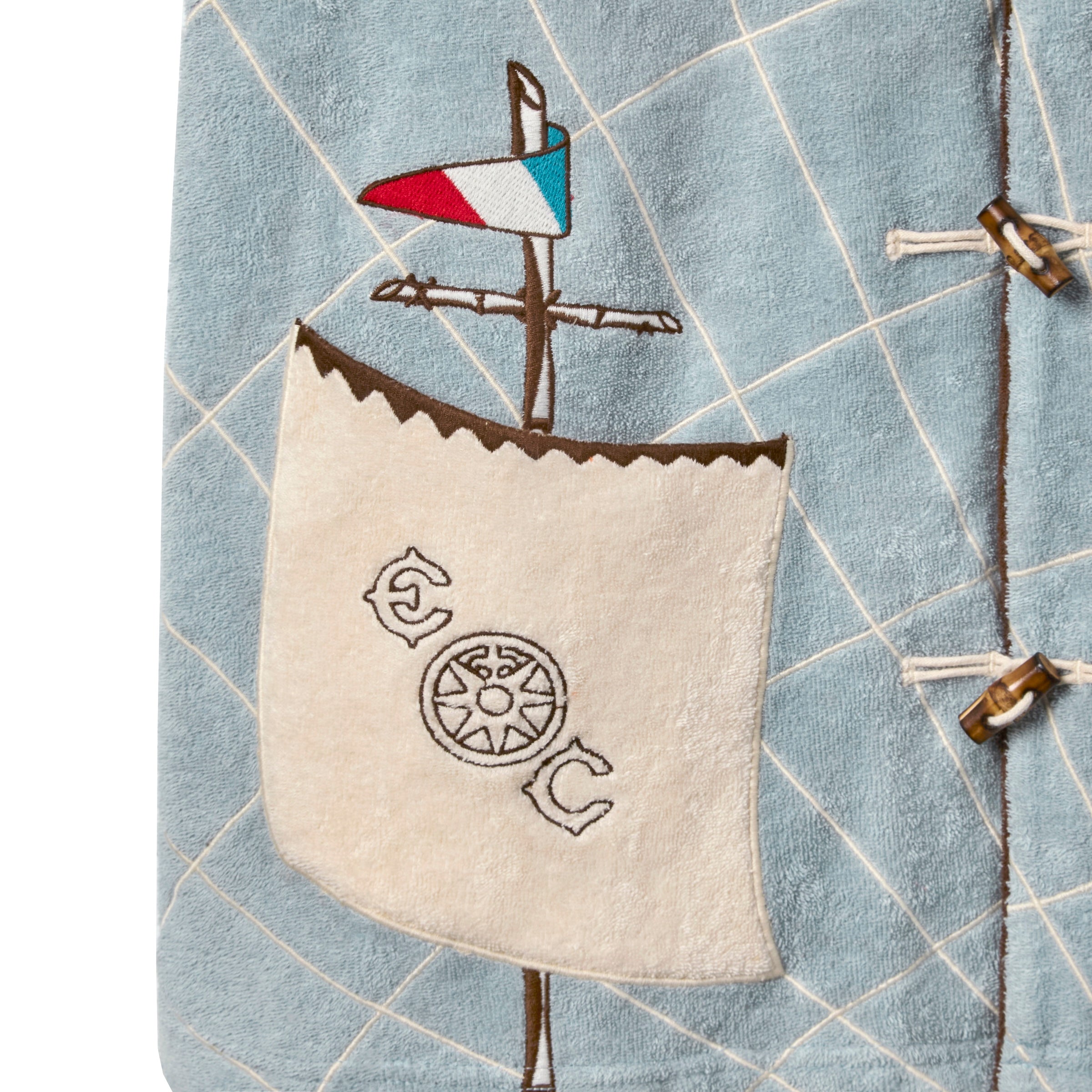 Close-up of front pocket featuring letters “EC” on either side of a ship’s wheel.