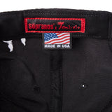 Inside of 'The Sopranos' 25th Anniversary 5-Panel Souvenir Cap that features a  Custom Sopranos x Tombolo interior label and "Made in USA" tag with an American flag.