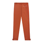 Back view of rust traveler pants.