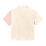 Back of conched out terrycloth crop cut in beige with left sleeve in coral pink