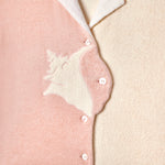 Close up of buttons showing embroidered conch shell