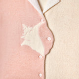 Close up of buttons showing embroidered conch shell