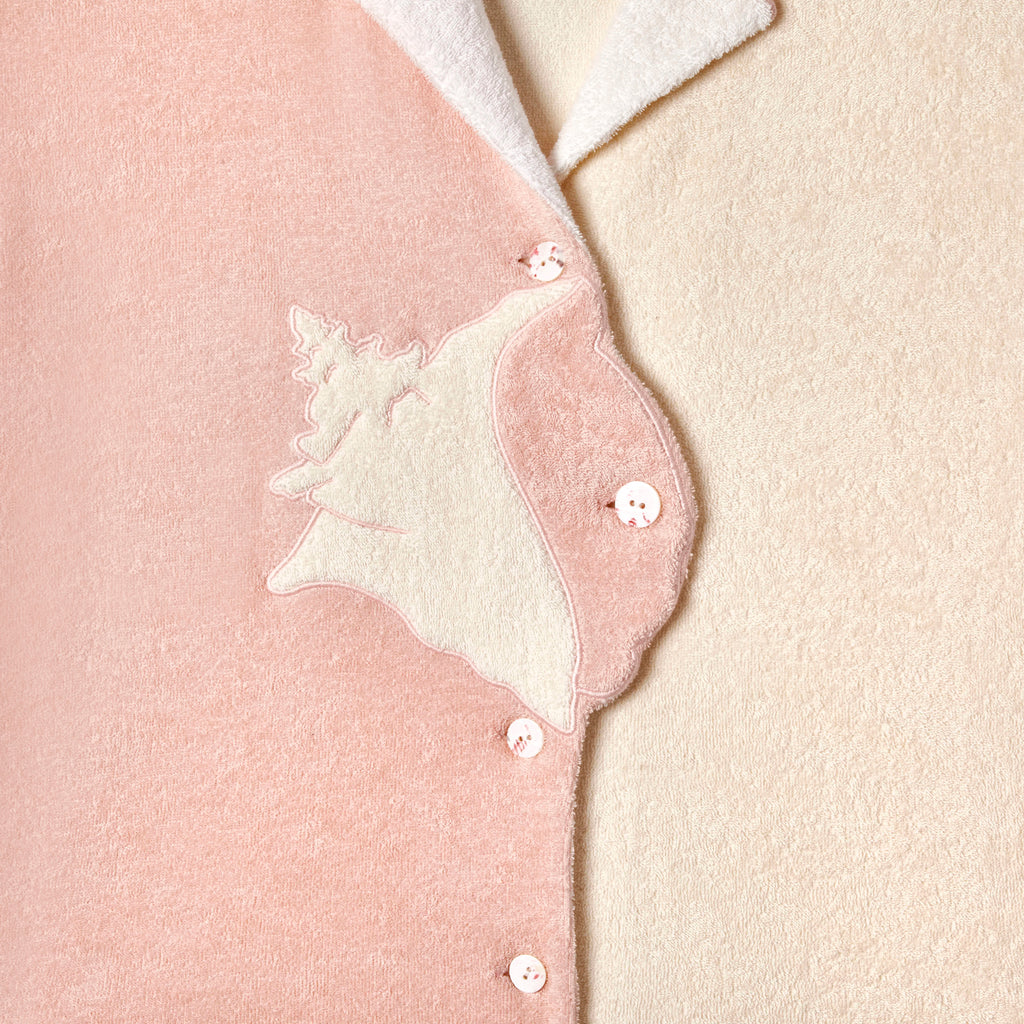 Close up of buttons showing embroidered conch shell