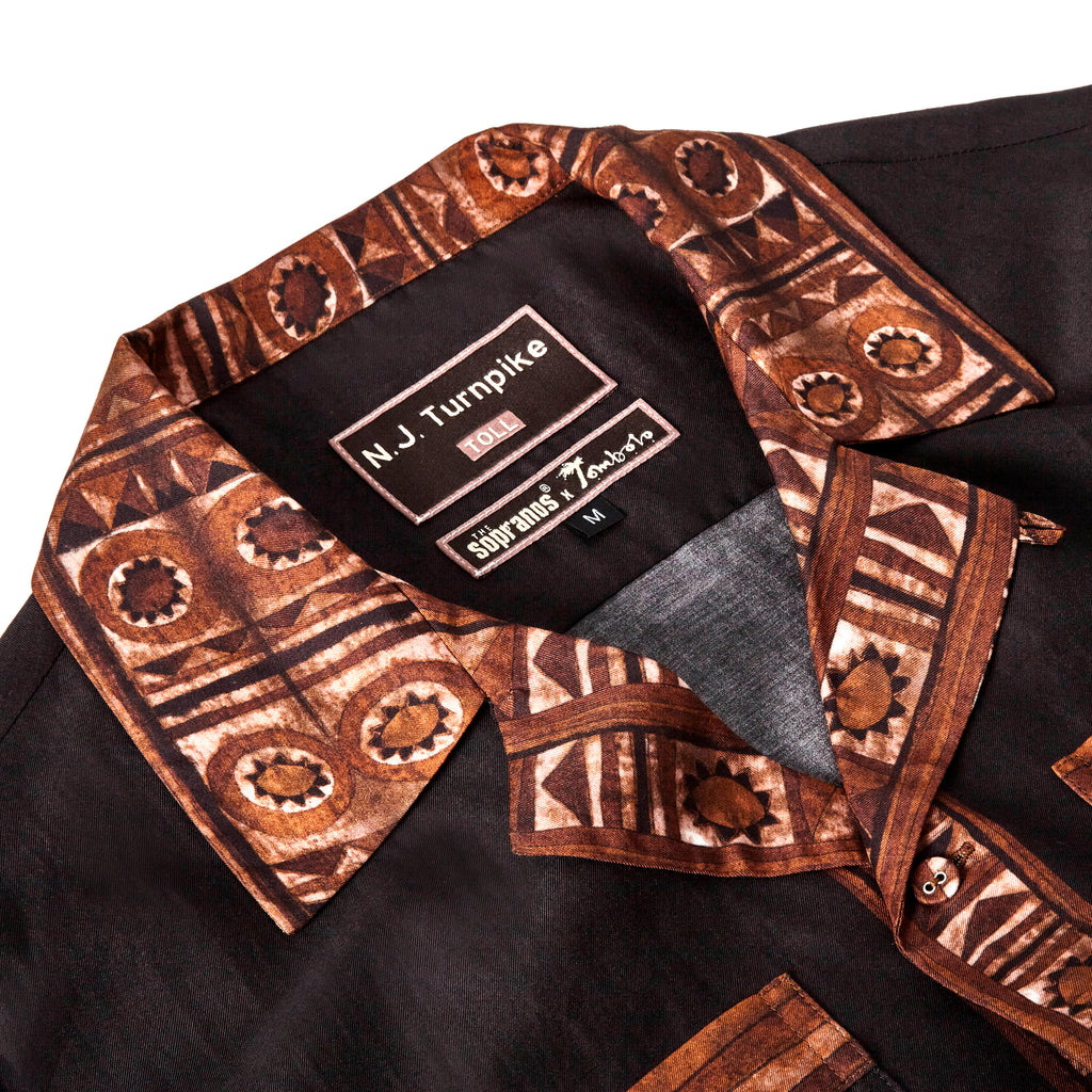 Close-up image of the 'The Sopranos' Turnpike Batik that highlights both the contrasting batik collar, cuffs, placket, and bottom sweep as well as the custom woven 'The Sopranos' x Tombolo' collaboration label