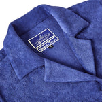 Close-up shot of 'The Sopranos' Vesuvio Cabana ~ Crop Cut that emphasizes the Custom 'The Sopranos' x Tombolo woven interior label and distinct V shape collar.