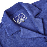 Close-up shot of 'The Sopranos' Vesuvio Cabana ~ Crop Cut that emphasizes the Custom 'The Sopranos' x Tombolo woven interior label and distinct V shape collar.