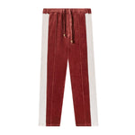 Front-facing product image of 'The Sopranos' Pie-O-My Track pants made of Organic Cotton Velour that features a burgundy and pink velour paneling, sewn pleats, an elasticized waist linked to drawstrings with varnished wood stoppers, and concealed pocket on side seam.