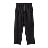 Black linen drawstring pants with a relaxed fit, elastic waistband, and side pockets.