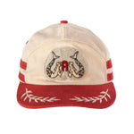 A beige and red 'Le Sirenuse' 7-Panel Souvenir Cap with hand-embroidered goldwork patch featuring Le Sirenuse, contrast brim and top button, and floral jacquard seam tape.