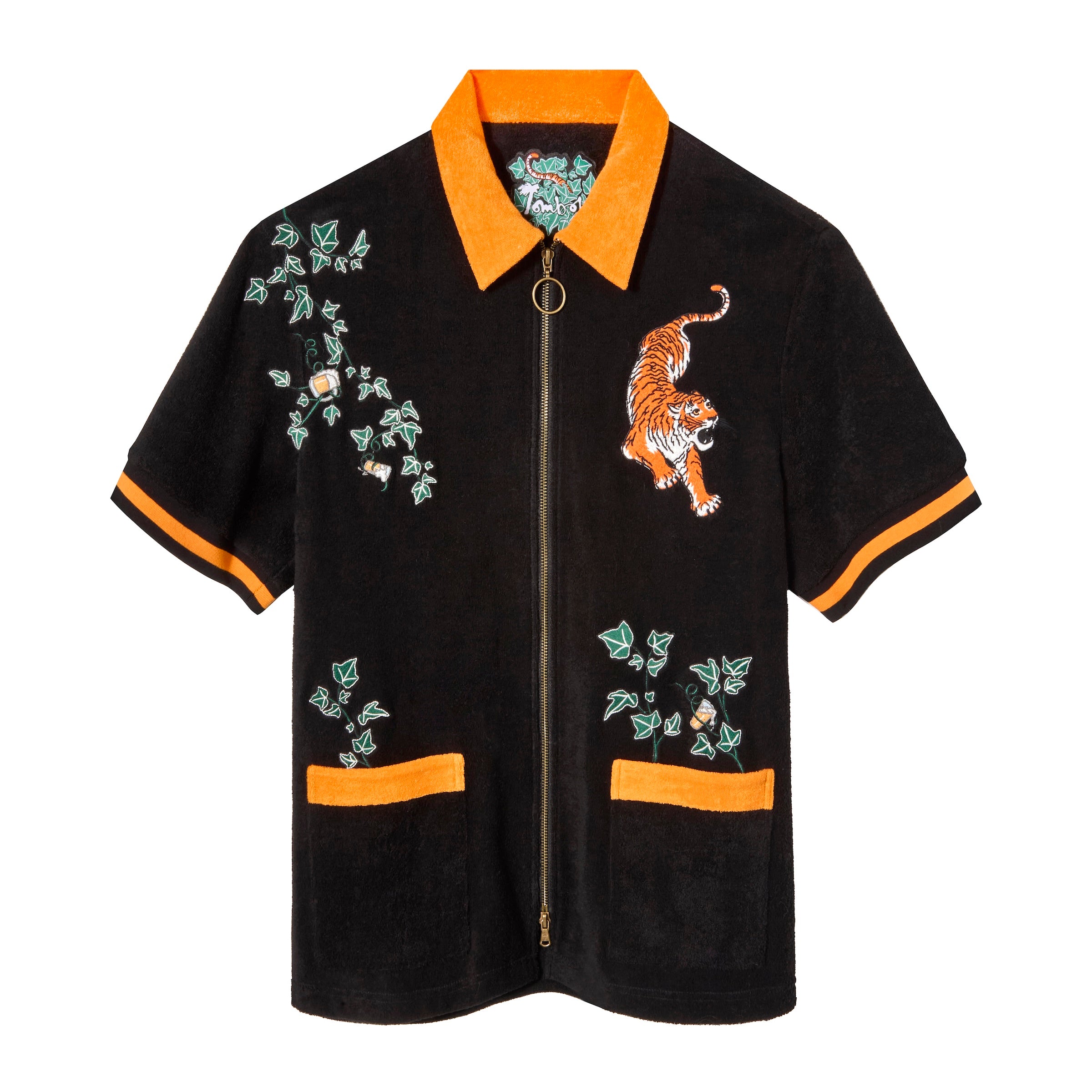 Short-sleeve black terry cloth zip-up shirt with orange collar, sleeve cuffs, and pocket trim. Features embroidered tiger, green ivy, and hidden beverages. 