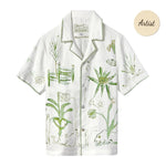 A short-sleeve white button-down shirt with green botanical and abstract designs.