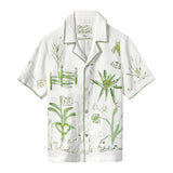 A short-sleeve white button-down shirt with green botanical and abstract designs.