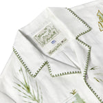 Close-up of Tombolo & Mary Ball interior label, featuring green flower drawings. 