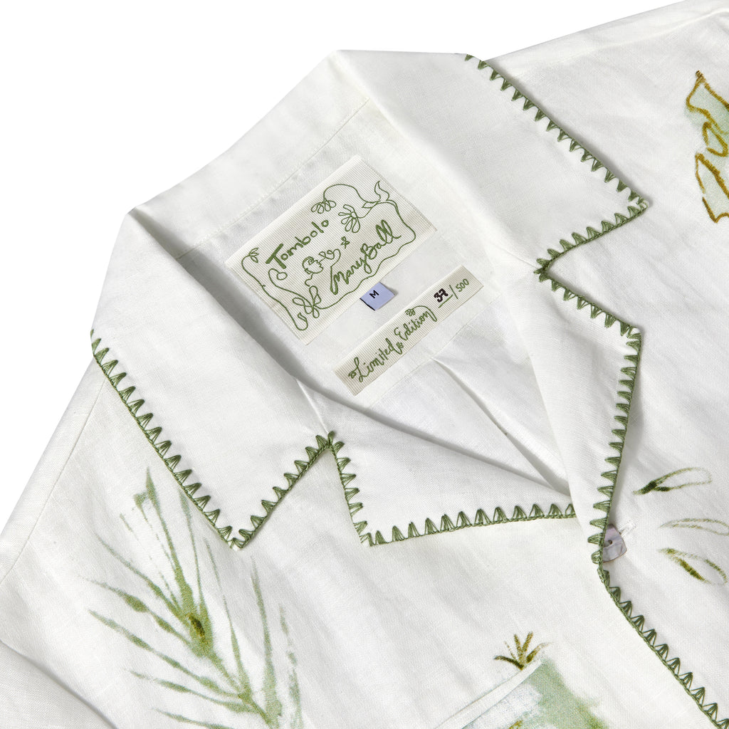 Close-up of Tombolo & Mary Ball interior label, featuring green flower drawings. 