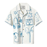 A white short-sleeve shirt with abstract blue embroidery featuring flowers, birds, stars, and faces, with detailed stitching along the edges.