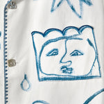 Detail shot of one of the abstract faces on the 'Seasons of Change' by Mary Ball Shirt. 