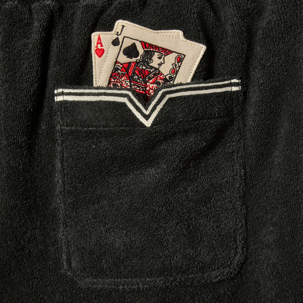Detailed image of the pocket, with two playing cards poking out. (Ace of Hearts and Jack of Spades)