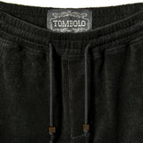 Close-up image of elastic waistline, and interior label reading 'Tombolo.'
