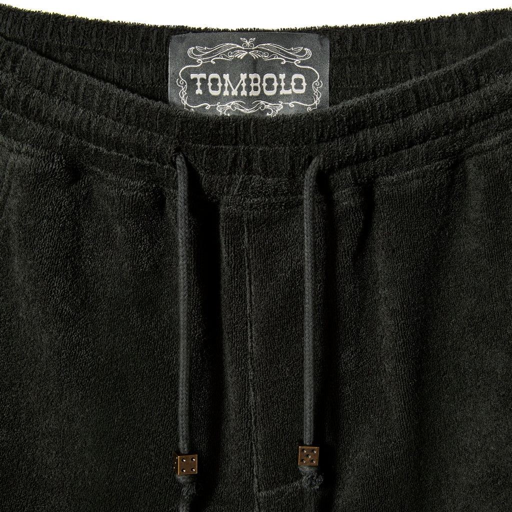 Close-up image of elastic waistline, and interior label reading 'Tombolo.'
