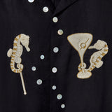 Close up of gold and cream seahorses with white buttons that form a trail of bubbles up the front.