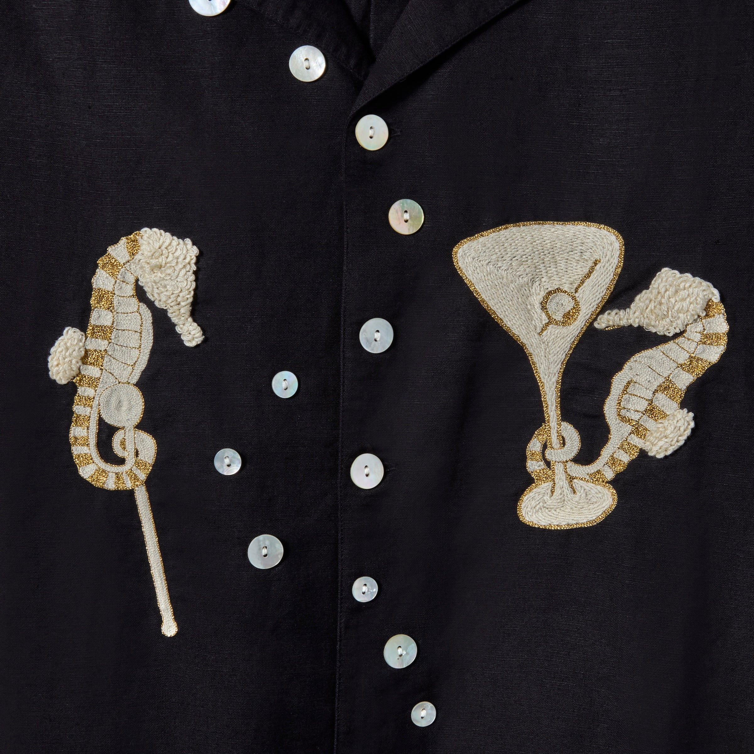 Close up of gold and cream seahorses with white buttons that form a trail of bubbles up the front.