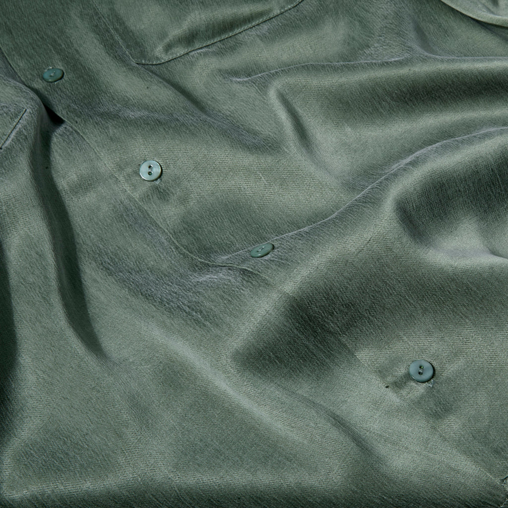 Close-up of the green silky fabric. 