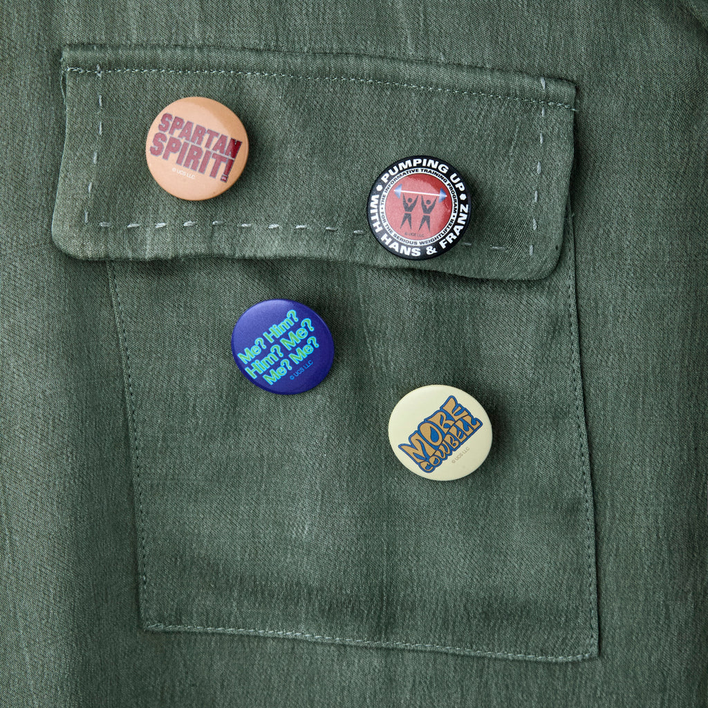 Close-up of some of the 'SNL' pins, featuring iconic SNL moments or quotes. 