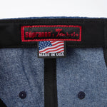 Close-up product image of 'The Sopranos' Fowl Play 6-Panel Souvenir Cap's custom Sopranos x Tombolo interior label in addition to 'Made in USA' label.