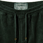 Close-up image of elastic waistline, and interior label reading 'Tombolo.'