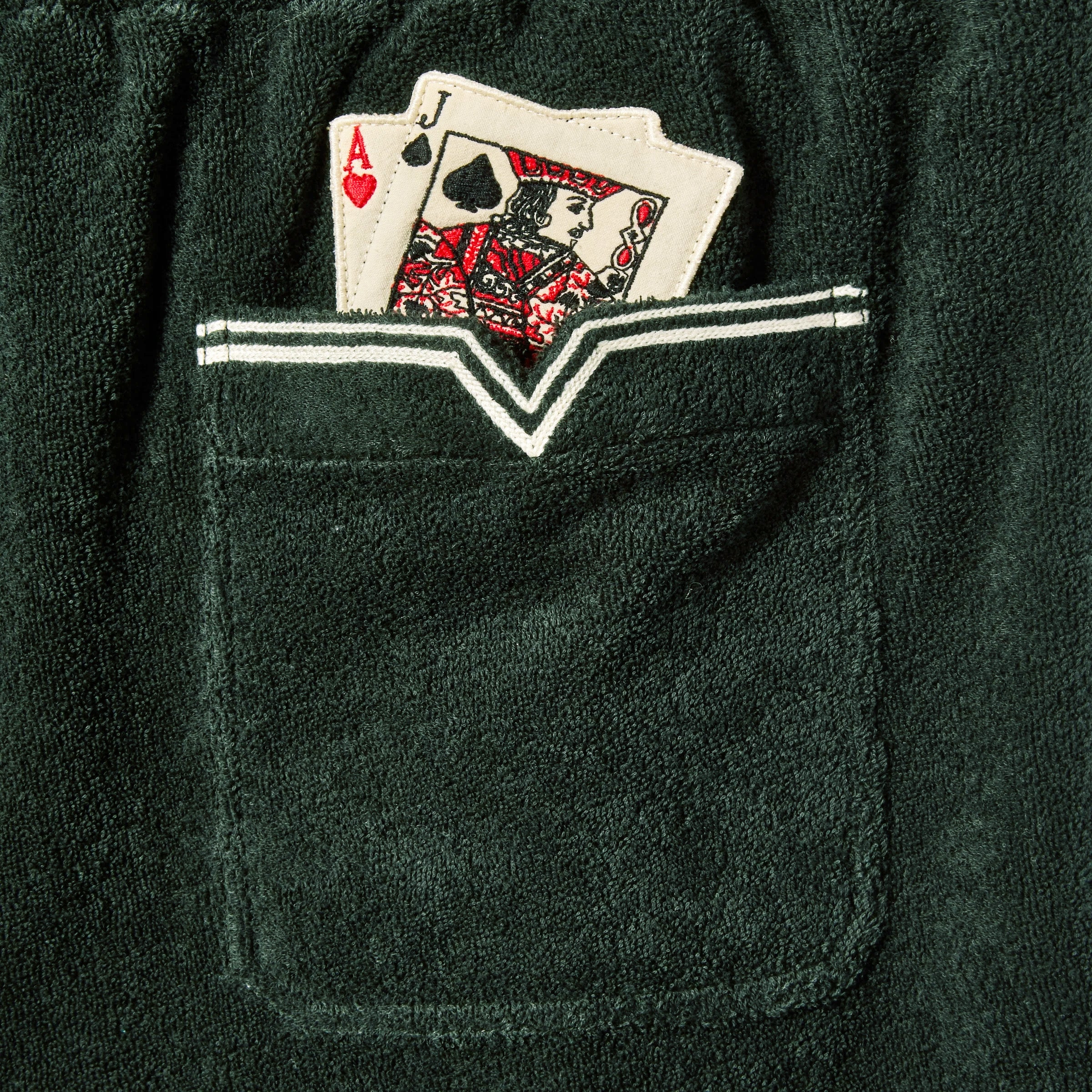 Detailed image of the pocket, with two playing cards poking out. (Ace of Hearts and Jack of Spades)