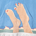 Close up of embroidered feet on poncho