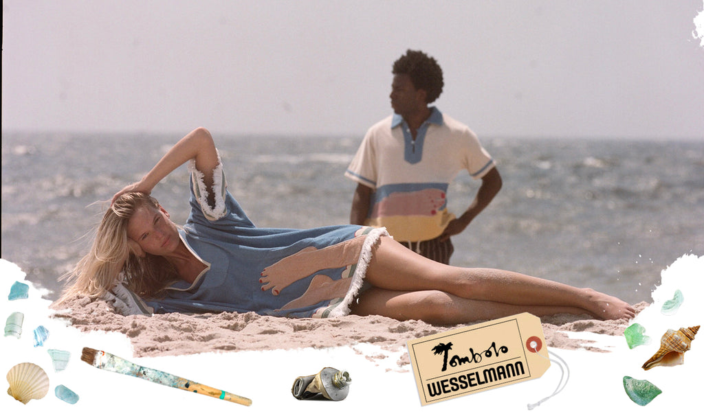 Tombolo Wesselmann showing woman wearing poncho lying across beach while man gazes off camera in the background