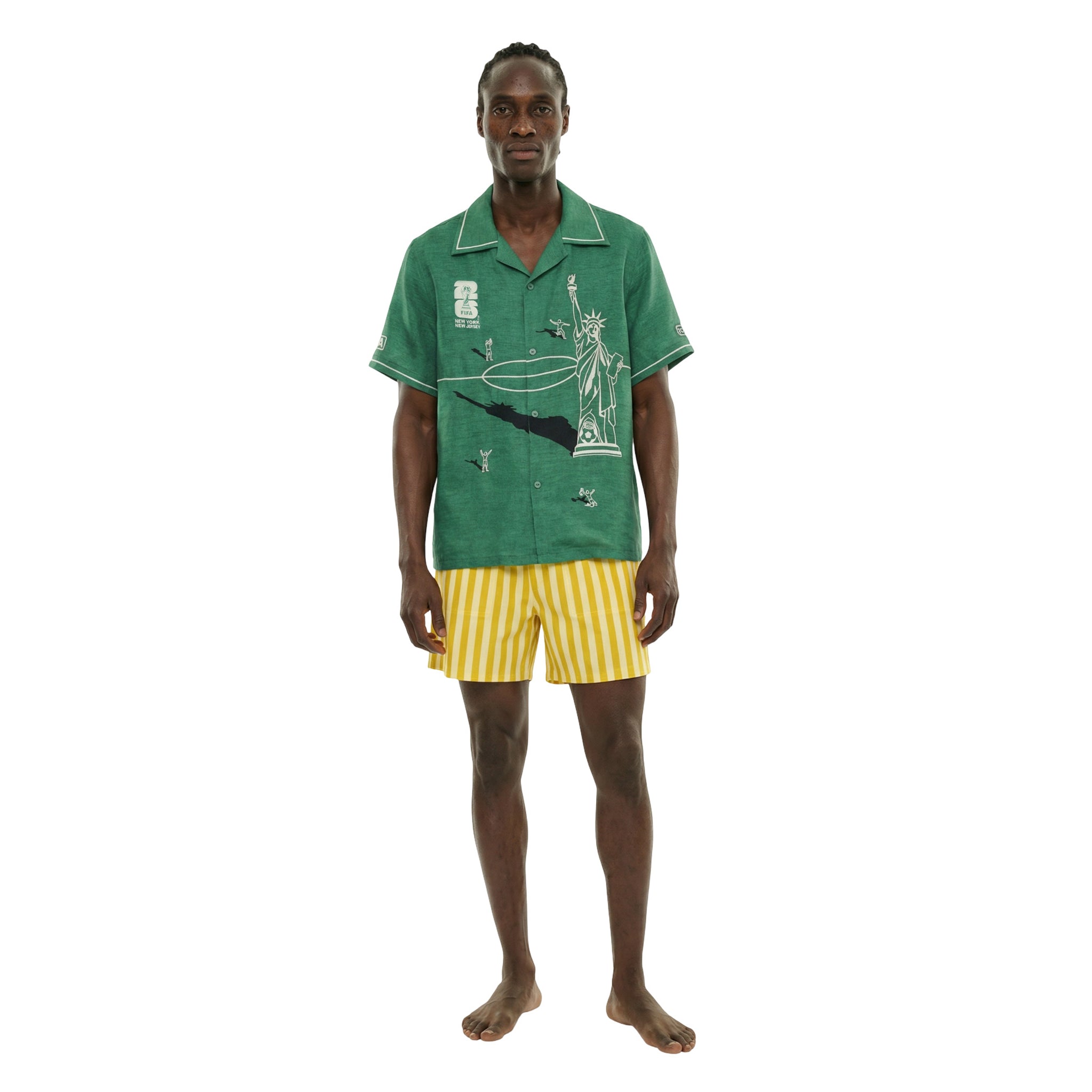 man in green fifa world cup 2026 shirt with yellow and cream striped trunks. 