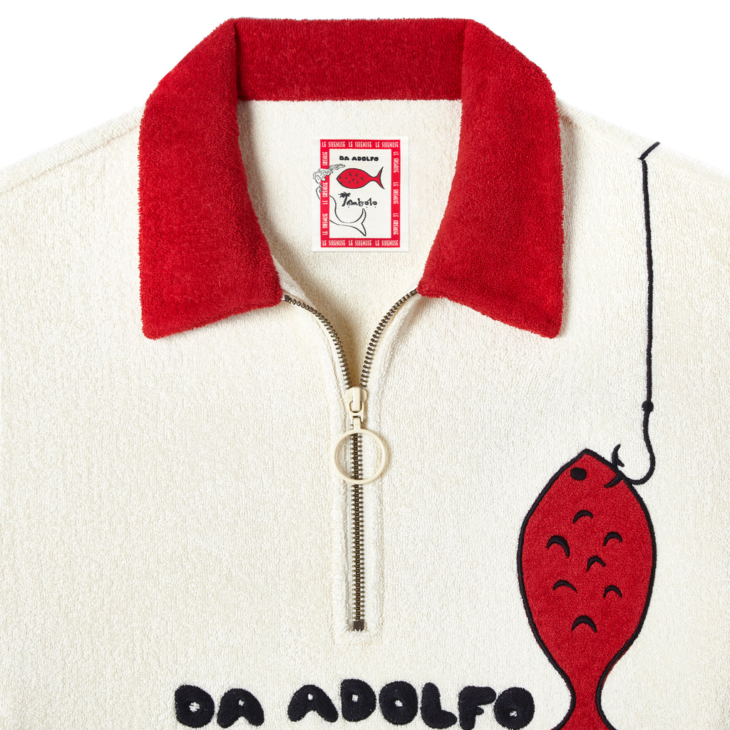 Close up of metal zipper, red terry cloth collar and interior label showing Da Adolfo x Tombolo collab